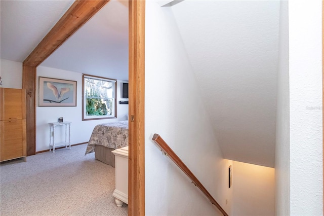 carpeted bedroom featuring beamed ceiling