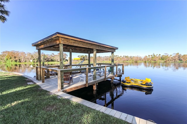 dock area with a water view and a lawn