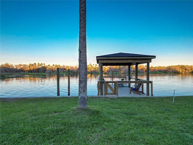 view of dock featuring a water view and a yard