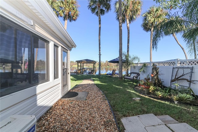 view of yard with a gazebo and a water view