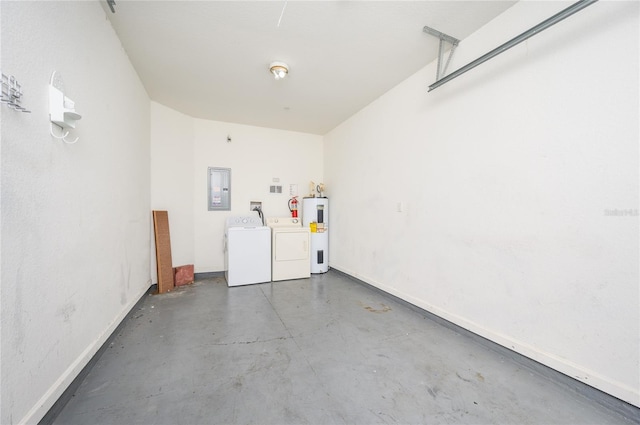 garage featuring washing machine and dryer, electric water heater, and electric panel