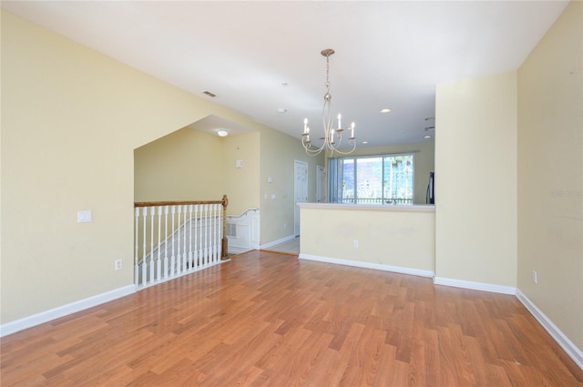 interior space featuring a notable chandelier and light wood-type flooring