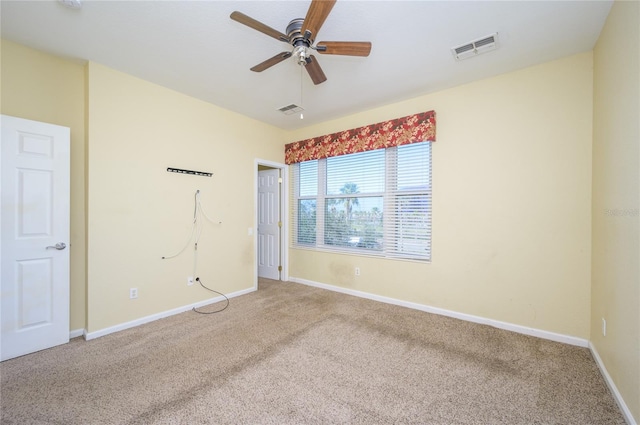 empty room with ceiling fan and carpet floors