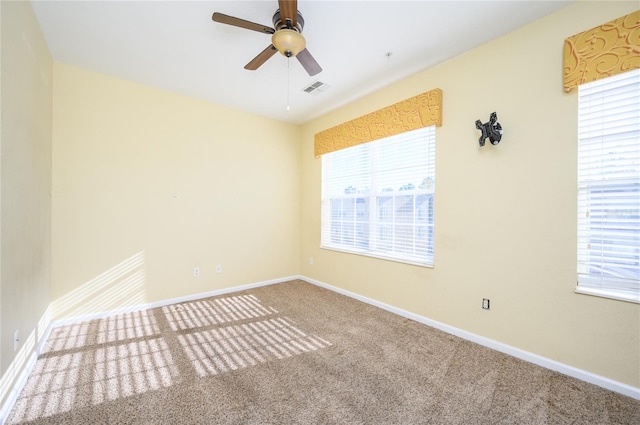 carpeted empty room featuring ceiling fan