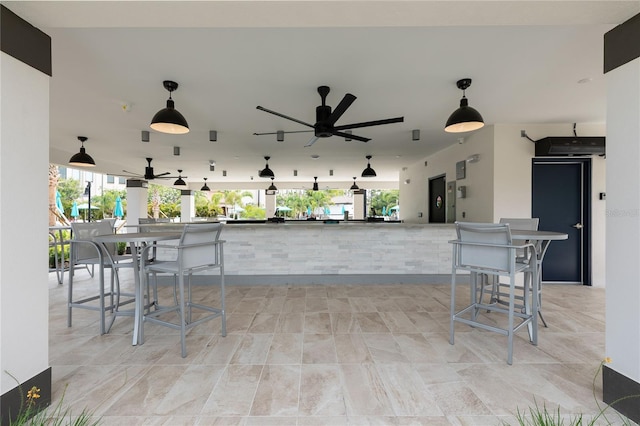 view of patio / terrace featuring ceiling fan and an outdoor bar