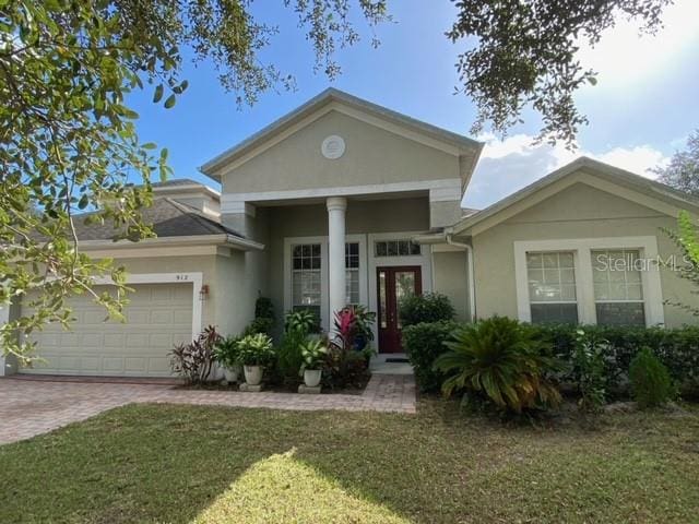 view of front of house featuring a front yard and a garage