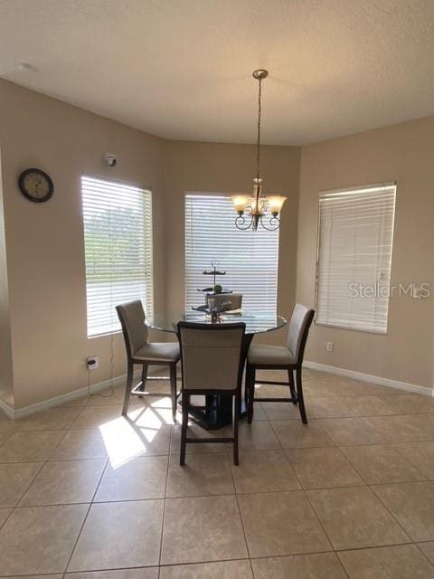 dining room featuring light tile patterned floors and a notable chandelier