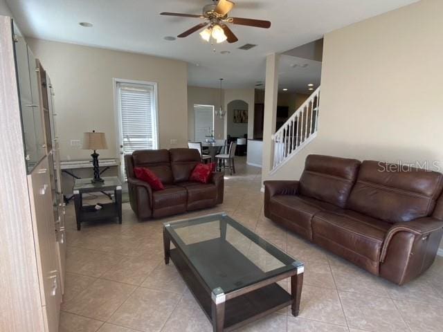 tiled living room featuring ceiling fan