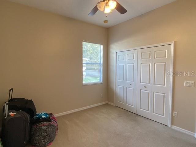 sitting room featuring ceiling fan and light colored carpet