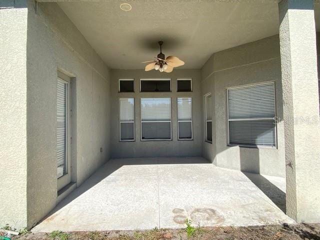 view of patio featuring ceiling fan