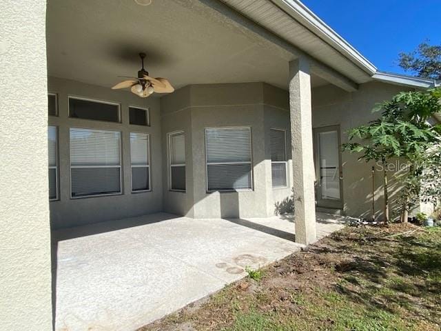 doorway to property featuring ceiling fan and a patio area