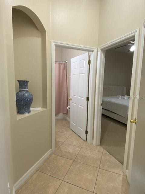 hall with light tile patterned floors