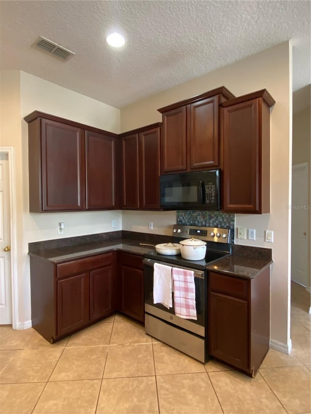 kitchen with stainless steel electric stove, tasteful backsplash, light tile patterned floors, and a textured ceiling