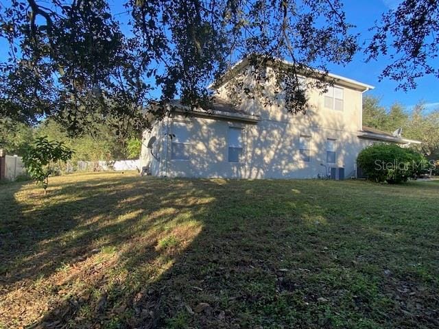 view of side of property with a yard