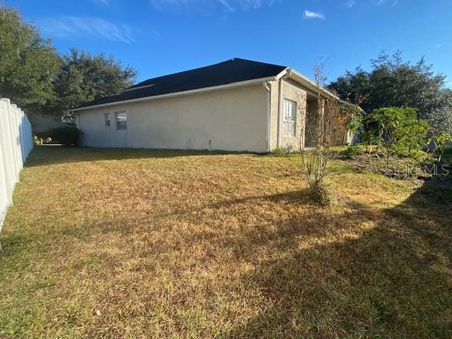 view of side of property featuring a yard