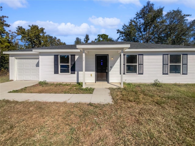 single story home featuring a front yard and a garage