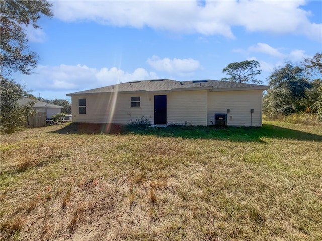 rear view of house featuring a yard