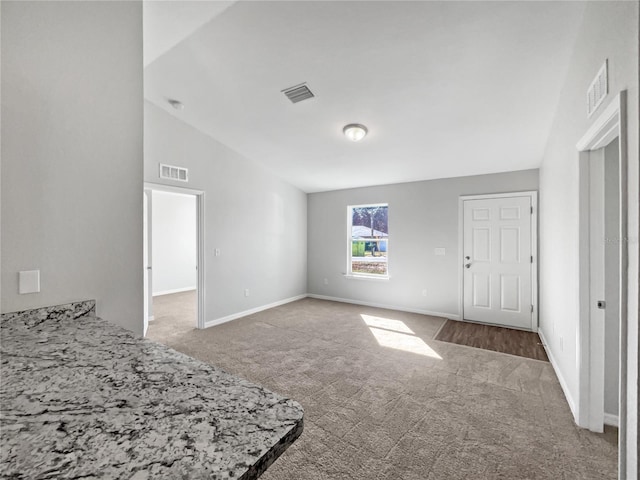 unfurnished bedroom featuring carpet floors and vaulted ceiling