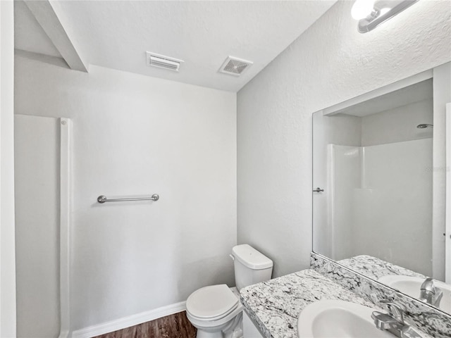 bathroom featuring vanity, toilet, and wood-type flooring