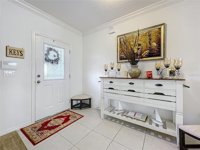 entrance foyer with light tile patterned flooring, ornamental molding, and a textured ceiling