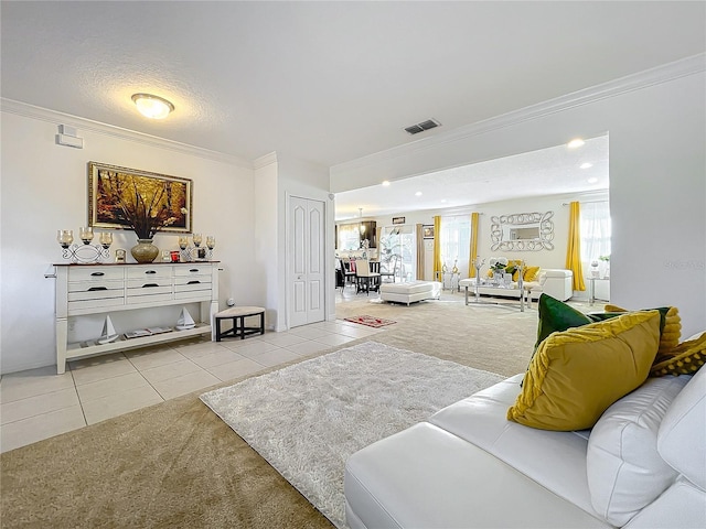 carpeted living room featuring a textured ceiling, a wealth of natural light, and ornamental molding