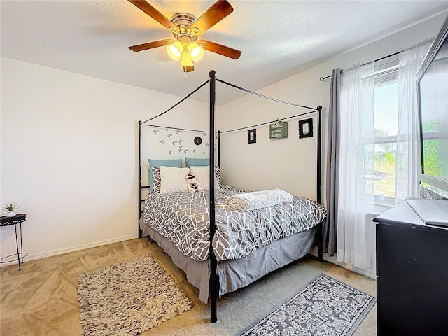 carpeted bedroom with a textured ceiling and ceiling fan