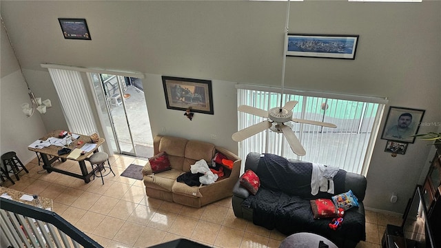 tiled living room featuring ceiling fan and plenty of natural light