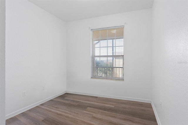 spare room with dark wood-type flooring