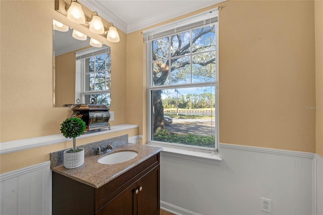 1054 Waterside Dr, Celebration, FL 34747 - bathroom featuring a wainscoted wall, vanity, healthy amount of natural light, and crown molding