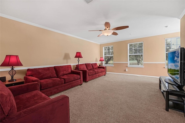 carpeted living room featuring a healthy amount of sunlight, ceiling fan, and crown molding