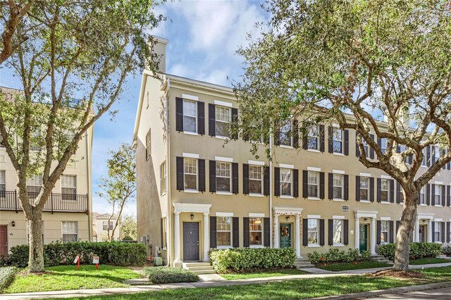 1054 Waterside Dr, Celebration, FL 34747 - townhome / multi-family property featuring stucco siding and a front lawn
