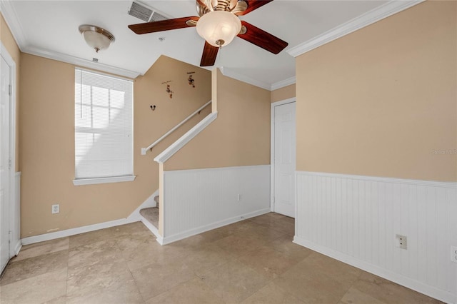 1054 Waterside Dr, Celebration, FL 34747 - spare room with a wainscoted wall, stairway, a ceiling fan, and ornamental molding