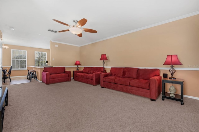 living room featuring ceiling fan, crown molding, and light carpet