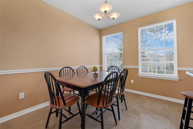 dining space featuring a notable chandelier