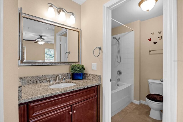 1054 Waterside Dr, Celebration, FL 34747 - full bathroom with toilet, vanity,  shower combination, tile patterned flooring, and a ceiling fan