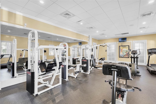 workout area with a drop ceiling and ornamental molding