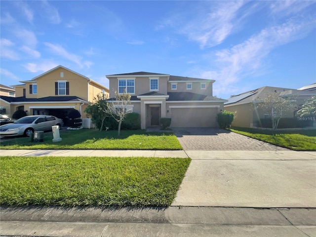 view of front of property with a garage and a front lawn