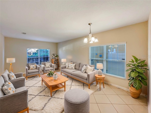 living room featuring a chandelier and light tile patterned flooring