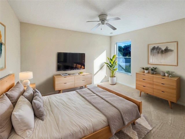 bedroom with carpet, ceiling fan, and a textured ceiling