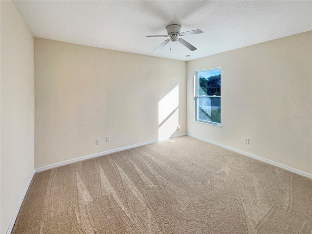 carpeted empty room featuring a textured ceiling and ceiling fan