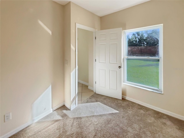 carpeted spare room featuring plenty of natural light