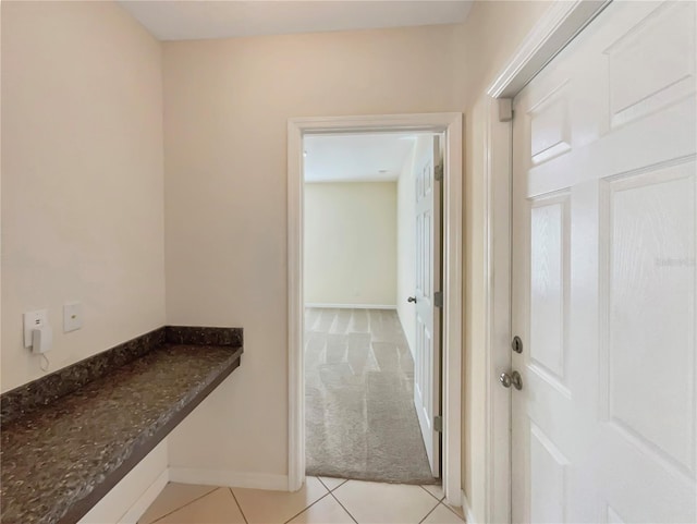 corridor featuring light colored carpet