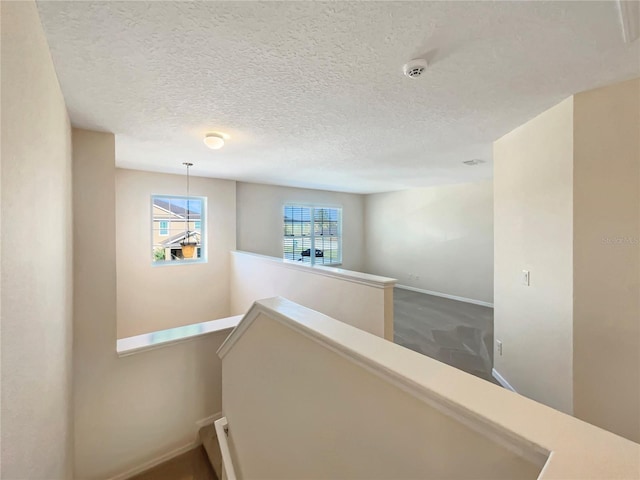 hallway featuring a textured ceiling