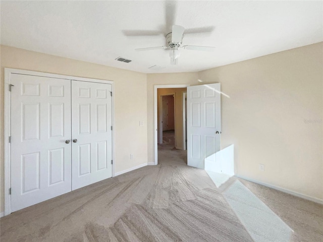 carpeted bedroom with ceiling fan and a closet