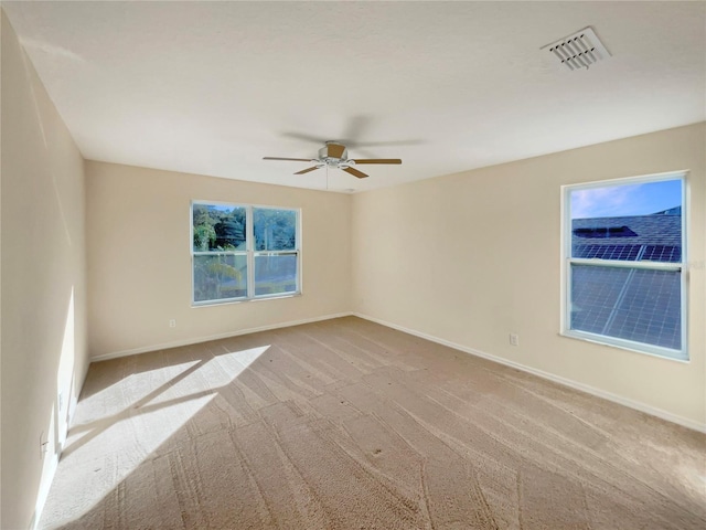 unfurnished room featuring light carpet and ceiling fan