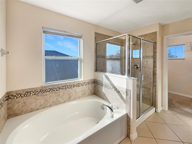 bathroom featuring tile patterned floors and shower with separate bathtub