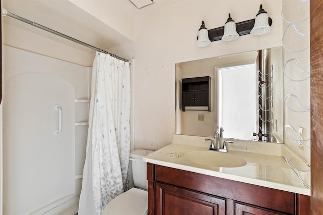 bathroom featuring vanity, curtained shower, and toilet