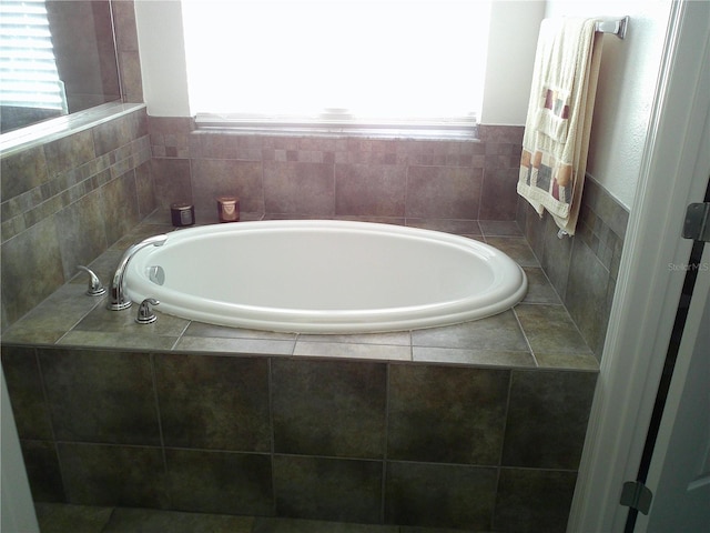 bathroom featuring a relaxing tiled tub