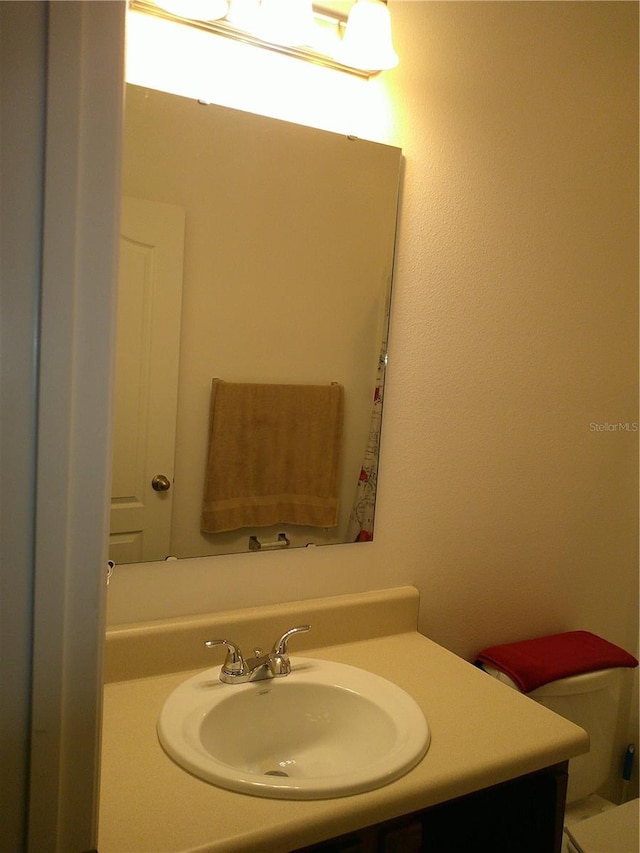 bathroom with vanity and toilet