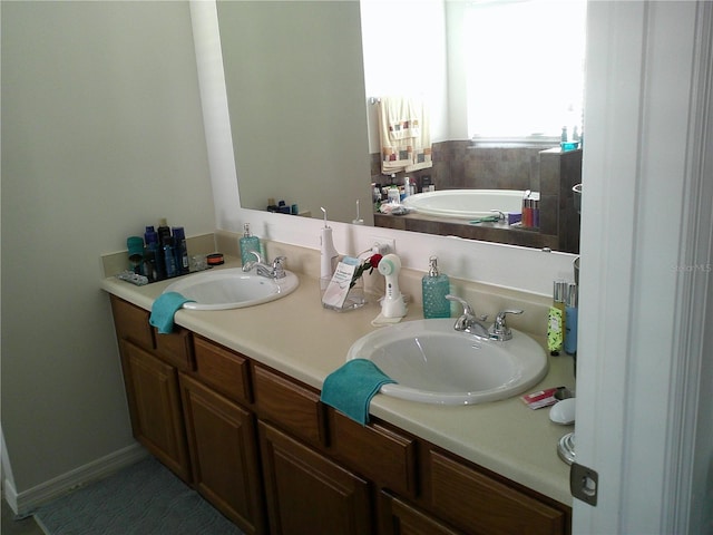 bathroom featuring a bath and vanity